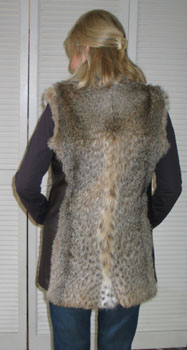 Vest back view shows off the slimming effect the addition of leather side panels has. The beauty of the lynx is highlighted at center back hem.